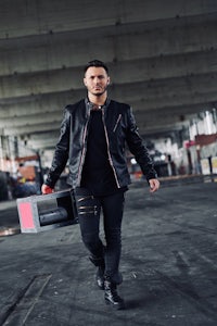 a man in a black jacket holding a briefcase